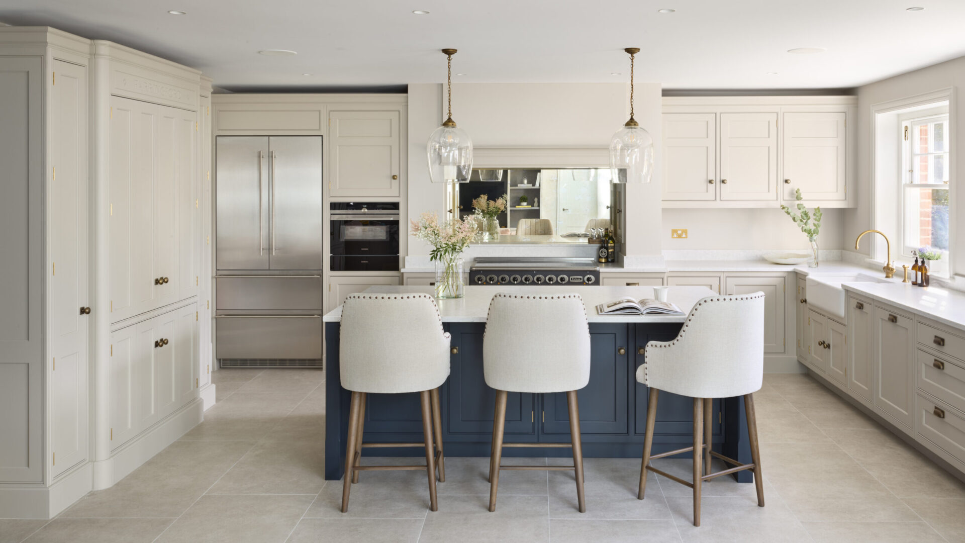 elegant beige kitchen with blue island cabinets