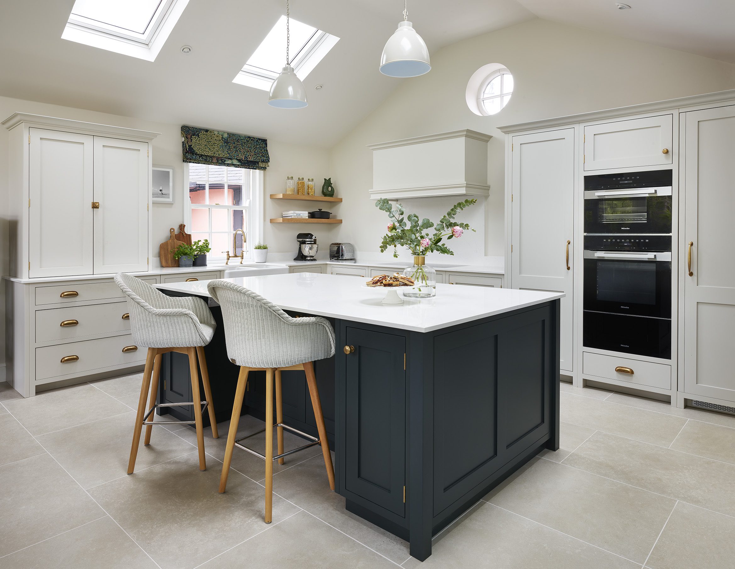 shaker kitchen in light grey and blue with gold hardware